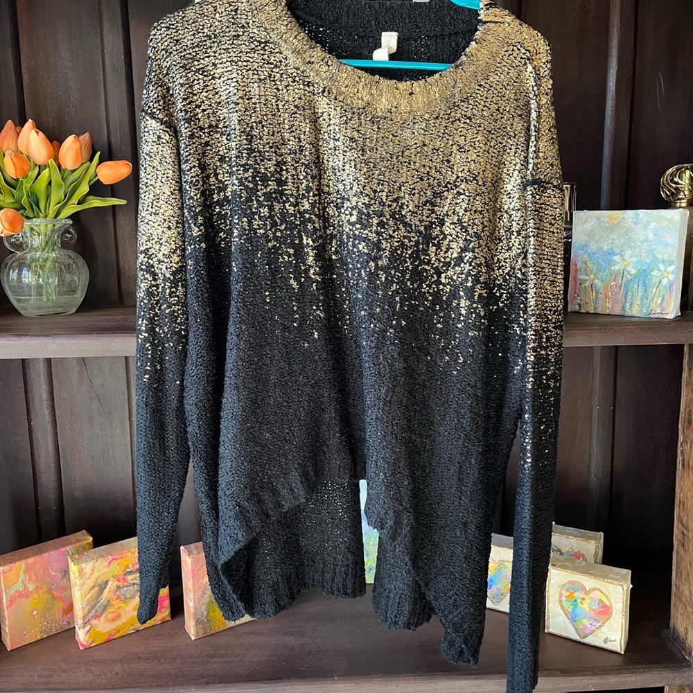 gold and black sweater with a slit in the back